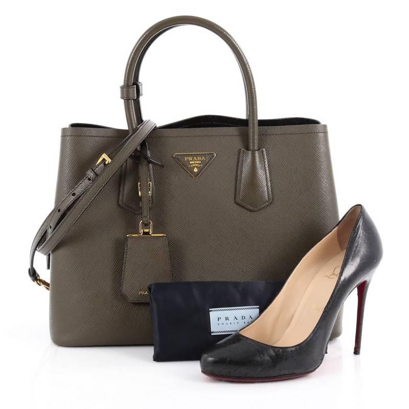 This authentic Prada Cuir Double Tote Saffiano Leather Small updates its popular Cuir line with a fresh, twist. Crafted from military green saffiano leather, this luxurious tote features dual-rolled top handles, side snap buttons, Prada's trademark