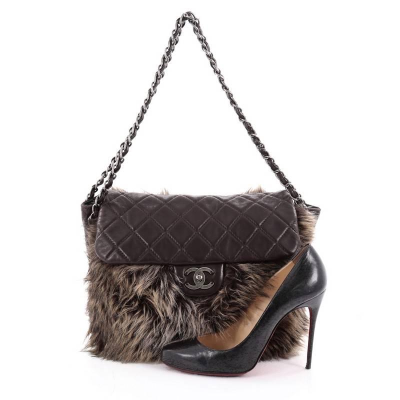This authentic Chanel Flap Shoulder Bag Faux Fur and Quilted Lambskin Medium is a bag with unique style that's ultra rare and collectible. Crafted from brown faux fur and quilted lambskin leather, this flap bag features dual woven-in leather