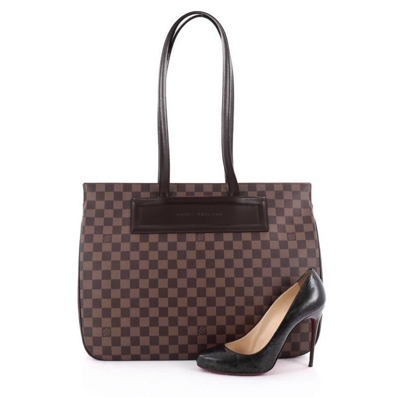 This authentic Louis Vuitton Parioli Handbag Damier GM is simple yet luxurious in design. Crafted from Louis Vuitton's popular damier ebene coated canvas, this chic shopper tote features dual flat handles, brown leather piping and trims with
