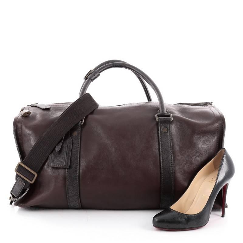 This authentic Louis Vuitton Commanche Handbag Utah Leather is a perfect travel companion that displays luxury and style. Crafted from brown leather, this bag features dual-rolled leather handles with aged bronze links, detachable strap, full rear