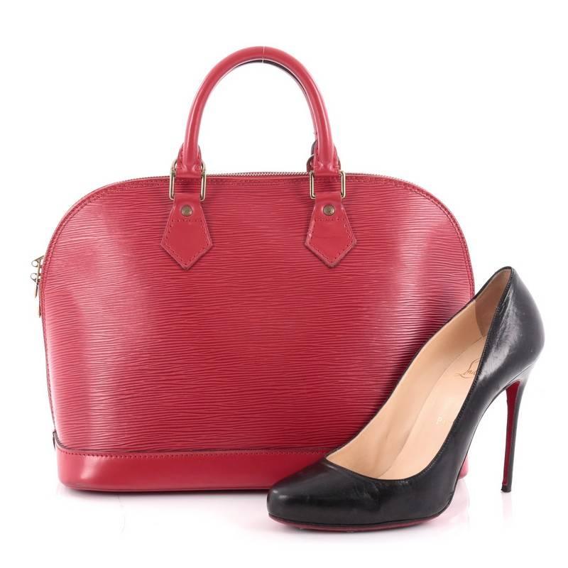 This authentic Louis Vuitton Vintage Alma Handbag Epi Leather PM is a chic and sophisticated bag perfect for your everyday use. Constructed from Louis Vuitton's signature sturdy red epi leather, this bag features dual-rolled leather handles, subtle