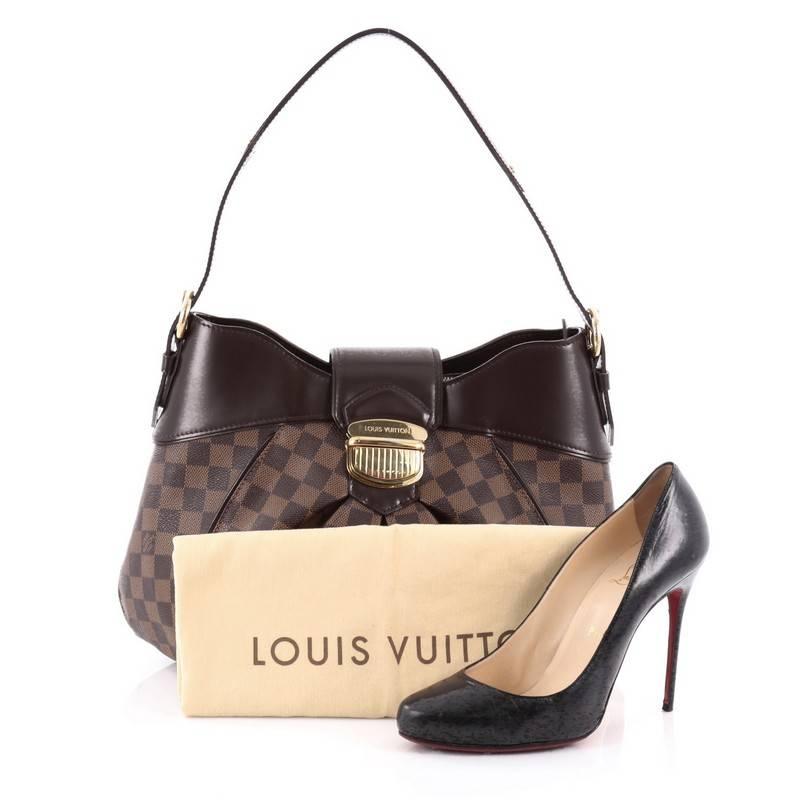 This authentic Louis Vuitton Sistina Handbag Damier MM is perfect for everyday use. Crafted from damier ebene coated canvas, this stylish, feminine bag features center pleating, smooth brown leather trims, flat buckle shoulder straps, and gold-tone