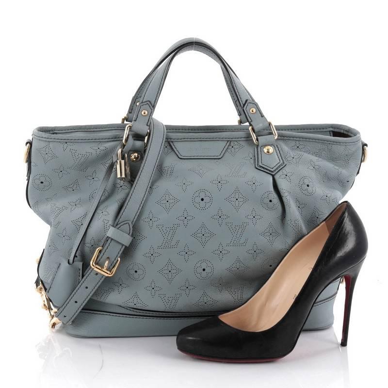 This authentic Louis Vuitton Stellar Handbag Mahina Leather PM displays understated simplicity and elegance with versatile functionality made for the modern woman. Crafted from blue perforated mahina leather, this soft-structured tote features dual