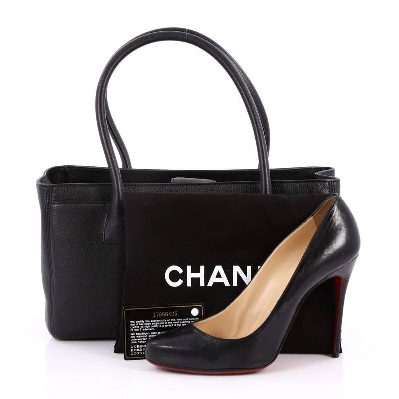 This authentic Chanel Cerf Executive Tote Leather Small is an ideal everyday accessory for the modern woman. Crafted from classic black leather, this functional tote features dual-rolled tall handles, front pocket with CC turn-lock closure,