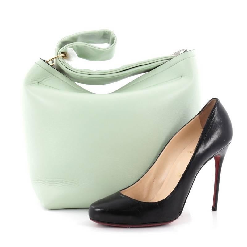 This authentic Victoria Beckham Tissue Bag Leather is an ultra soft pillowy pouch bag made for the stylish fashionista. Crafted from mint green leather, this lightweight bag features a textured gold key ring that doubles as a fastening, double zip