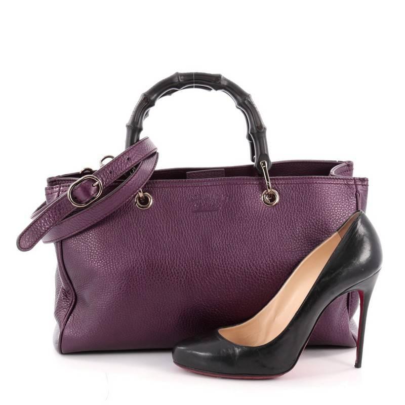 This authentic Gucci Bamboo Shopper Tote Leather Medium is a classic must-have. Crafted from purple leather, this simple yet stylish tote features Gucci's signature sturdy bamboo handles, protective base studs, stamped logo at the front, and bamboo