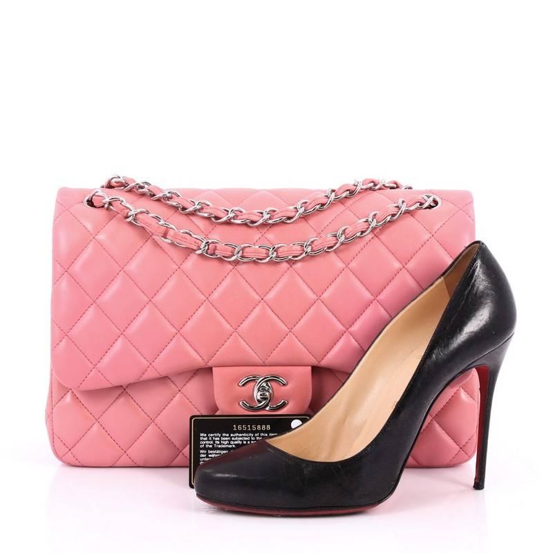 This authentic Chanel Classic Double Flap Bag Quilted Lambskin Jumbo exudes a classic yet easy style made for the modern woman. Crafted from pink quilted lambskin leather, this elegant flap features Chanel's signature diamond quilted design,