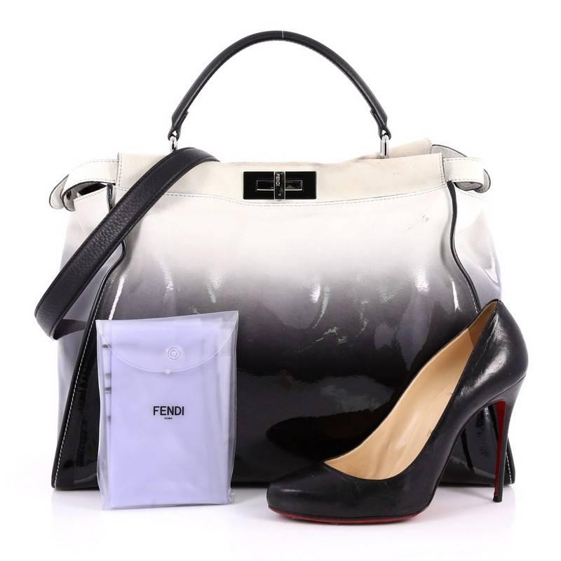 This authentic Fendi Peekaboo Handbag Ombre Patent Large is one of Fendi's best known designs exuding a luxurious yet minimalist appearance. Crafted in black patent leather and off-white suede ombre, this versatile and stylish satchel features flat