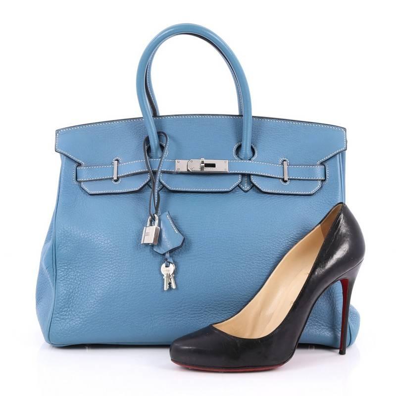 This authentic Hermes Birkin Handbag Blue Jean Clemence with Palladium Hardware 35 showcases subtle elegance. Finely crafted in beautiful, blue jean clemence leather, this piece features dual-rolled top handles, frontal flap, turn-lock closure,