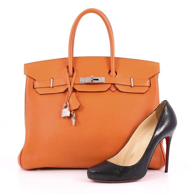 This authentic Hermes Birkin Handbag Orange Togo with Palladium Hardware 35 stands as one of the most-coveted bags. Crafted from scratch-resistant, iconic orange togo leather, this stand-out tote features dual-rolled top handles, frontal flap,