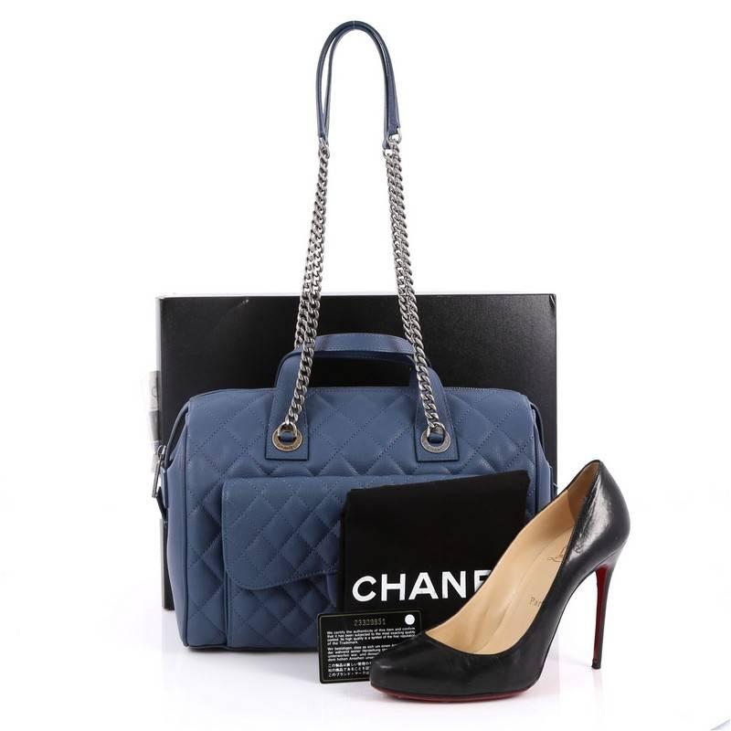 This authentic Chanel Two-Tone Front Pocket Bowling Bag Quilted Caviar Medium is ideal for everyday use. Crafted in blue quilted caviar leather, this bowling bag features dual leather top handles, chunky chain link strap, front flap pocket with two