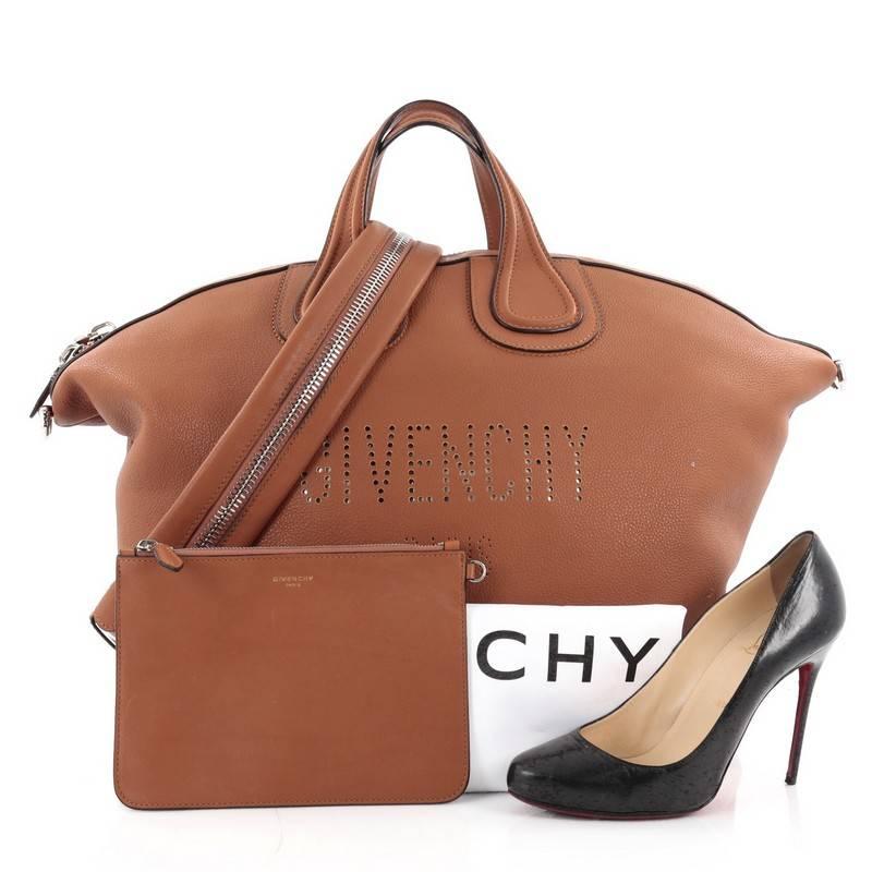 This authentic Givenchy Nightingale Satchel Waxed Leather Large is a luxurious yet casual accessory perfect for on-the-go moments. Constructed in brown waxed leather, this satchel features dual-leather handles, perforated Givenchy Paris lettering,