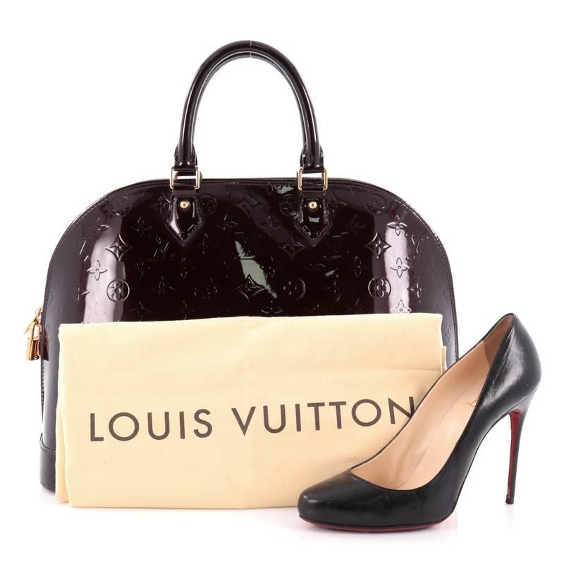 This authentic Louis Vuitton Alma Handbag Monogram Vernis GM is a fresh and elegant spin on a classic style that is perfect for all seasons. Crafted from Louis Vuitton's amarante monogram vernis, this dome-shaped satchel features dual-rolled