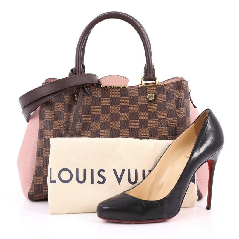 This authentic Louis Vuitton Brittany Handbag Damier makes an elegant statement with its contrast pairing. Crafted from damier ebene coated canvas Cuir Taurillon leather, this sophisticated and feminine bag features dual-rolled leather handles,