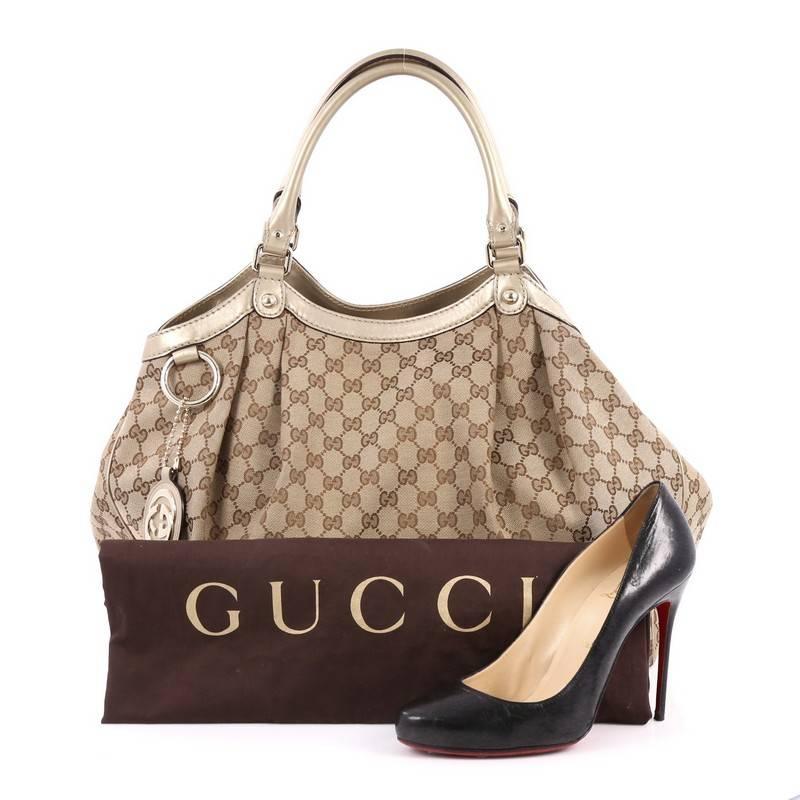 This authentic Gucci Sukey Tote GG Canvas Large is perfect for any casual or sophisticated outfit. Constructed from Gucci's light brown GG canvas with leather trims, this roomy tote features dual-rolled leather handles that sit comfortably on the