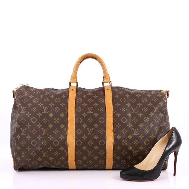 This authentic Louis Vuitton Keepall Bag Monogram Canvas 55 is the perfect purchase for a weekend trip, and can be effortlessly paired with any outfit from casual to formal. Crafted with traditional Louis Vuitton monogram coated canvas, this classic