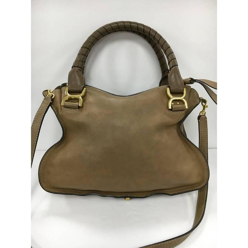 This authentic Chloe Marcie Satchel Leather Medium is perfect for the on-the-go fashionista. Constructed from brown leather, this popular satchel features wrapped leather handles, horseshoe stitched front flap, and gold-tone hardware. Its top zipped