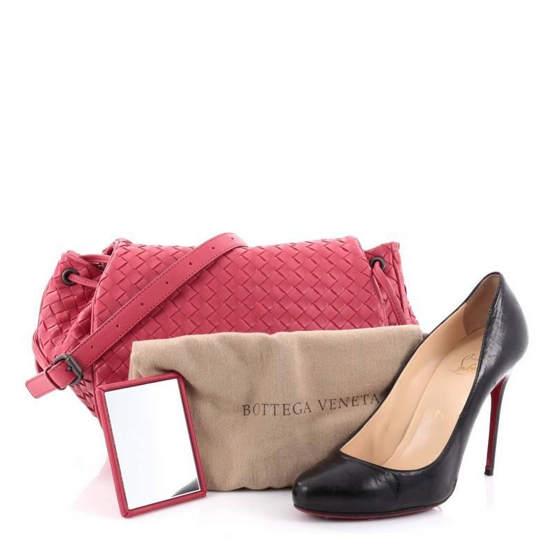 This authentic Bottega Veneta Flap Messenger Bag Intrecciato Nappa Medium showcases classic sophistication and modern utility made for the modern woman. Crafted from dark pink intrecciato nappa leather, this stylish flap messenger bag features