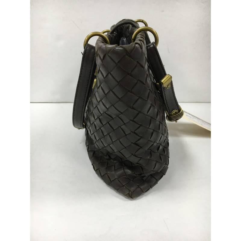 This authentic Bottega Veneta Capri Tote Intrecciato Nappa Small is a finely crafted tote that exudes an understated elegance. Crafted from dark brown leather woven in Bottega Veneta's signature intrecciato method, this functional and feminine tote
