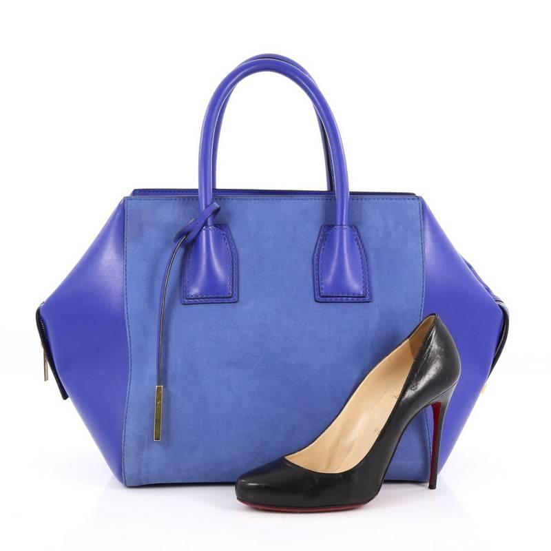 This authentic Stella McCartney Cavendish Boston Bag Faux Suede and Faux Leather Large is perfect for casual day-to-day excursions. Crafted in blue faux suede and faux leather, this bag features dual-rolled leather handles, protective base studs and