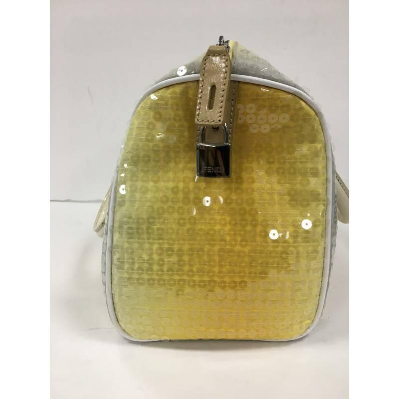 This authentic Fendi Boston Sequin Embellished Zucchino Coated Canvas Medium is an easy to carry, everyday handbag that is both stylish and functional with a twist. Crafted from yellow and blue sequin embellished zucchino coated canvas, this bag