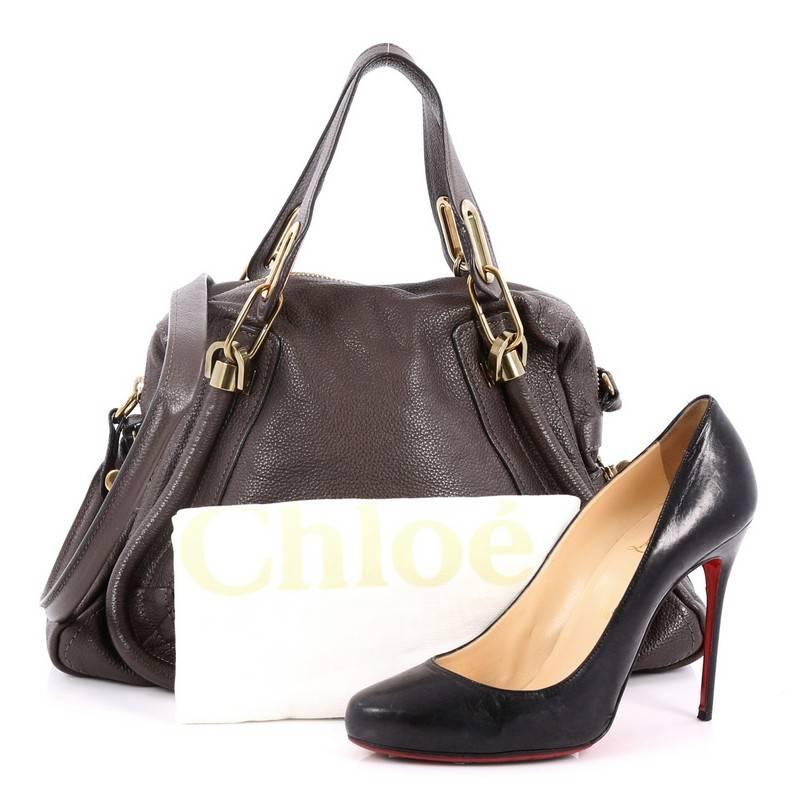 This authentic Chloe Paraty Top Handle Bag Leather Medium mixes everyday style and functionality perfect for the modern woman. Crafted from dark taupe leather, this versatile bag features dual flat handles, piped trim details, side twist locks, and