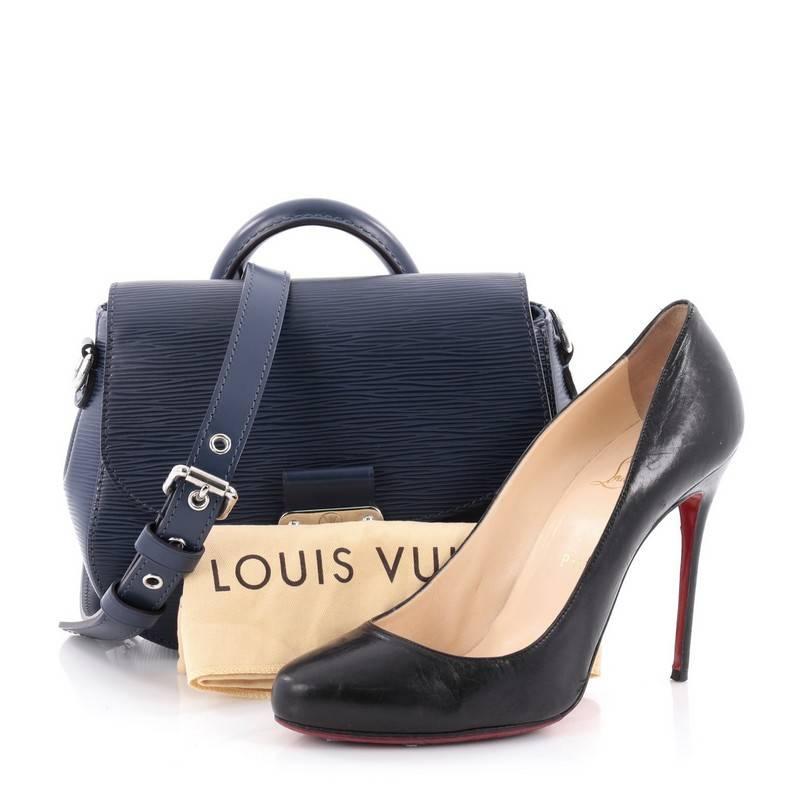 This authentic Louis Vuitton Eden Handbag Epi Leather PM mixes traditional style with a fun twist made for everyday excursions. Crafted in sturdy, navy blue epi leather, this satchel features single loop leather handle, frontal flap, detachable