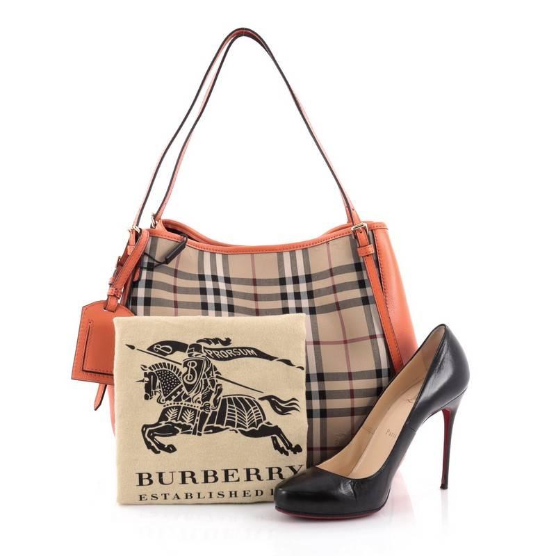 This authentic Burberry Canterbury Tote Horseferry Check Canvas and Leather Small is perfect for casual wear. Crafted in brand's signature horseferry check canvas with orange leather panels, this elegant tote features leather shoulder straps,