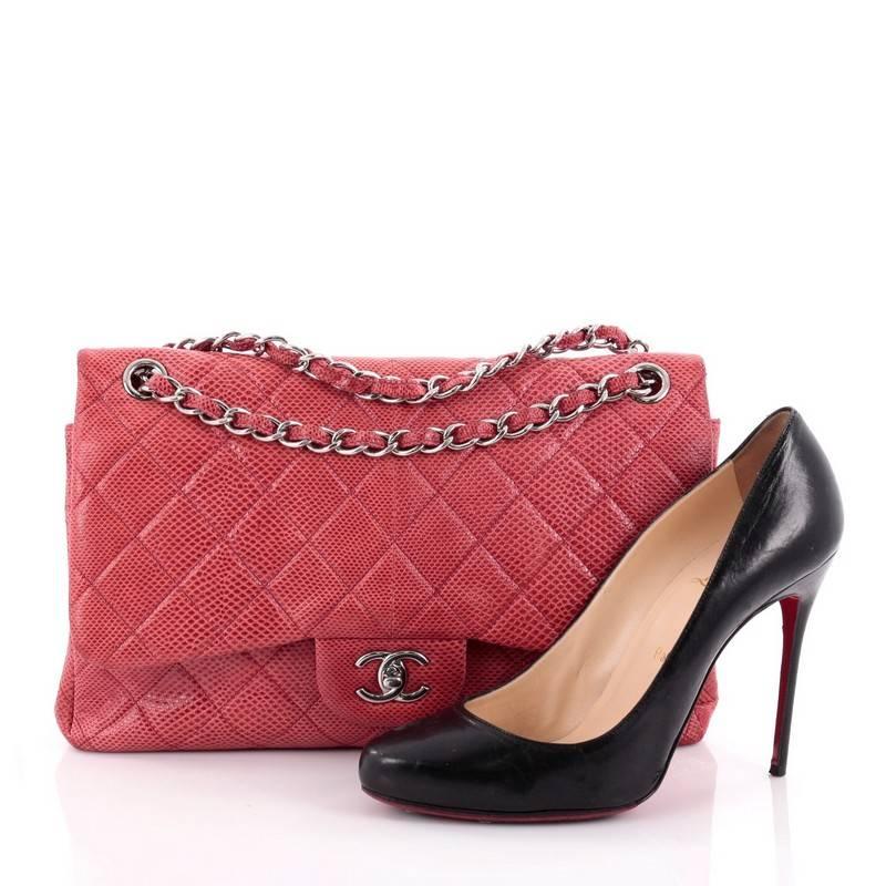 This authentic Chanel Classic Double Flap Bag Quilted Lizard Jumbo is one of the brand's most popular style. Crafted from genuine red lizard, this elegant flap features Chanel's signature diamond quilted design, woven-in lizard chain straps,