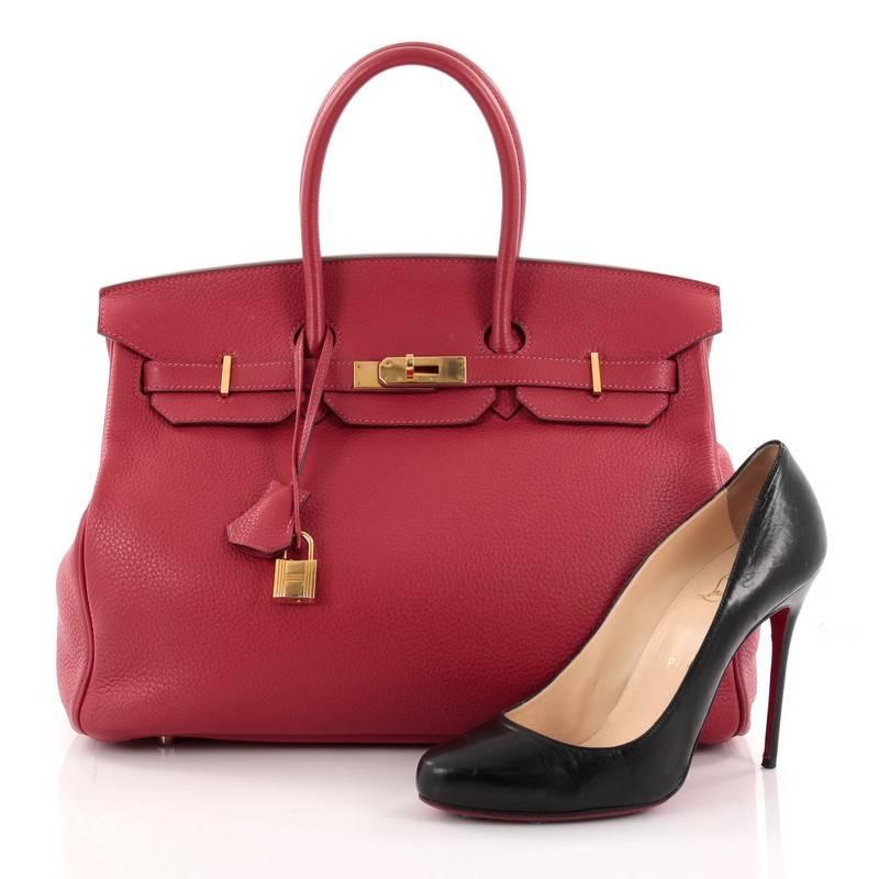 This authentic Hermes Birkin Handbag Rouge Casaque Clemence with Gold Hardware 35 stands as one of the most-coveted bags. Crafted from scratch-resistant, iconic rouge casaque red leather, this standout tote features dual-rolled top handles, frontal