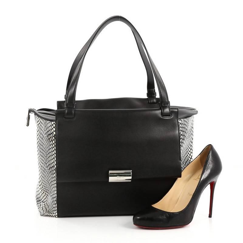 This authentic Salvatore Ferragamo Bitter Flap Tote Leather with Snakeskin Large is a stylish and functional, chic bag perfect for the modern woman. Crafted from black leather with genuine off-white snake skin on side panel, this bag features dual
