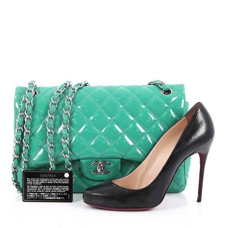 This authentic Chanel Classic Double Flap Bag Quilted Patent Jumbo exudes a classic yet easy style made for the modern woman. Crafted from dark mint green patent leather, this elegant flap features Chanel's signature diamond quilted design, woven-in