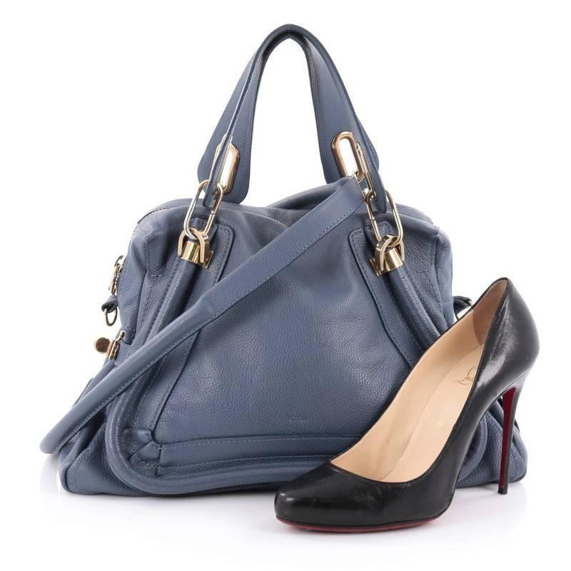 This authentic Chloe Paraty Top Handle Bag Leather Medium mixes everyday style and functionality perfect for the modern woman. Crafted from blue leather, this versatile bag features dual flat handles, piped trim details, side twist locks, and