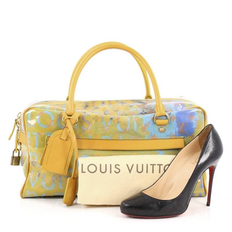 This authentic Louis Vuitton Limited Edition Pulp Weekender Bag PVC Over Monogram Denim PM is a spectacular limited edition bag from Louis Vuittons' runway collection. Crafted from stonewashed blue monogram denim canvas, splashed with beautiful