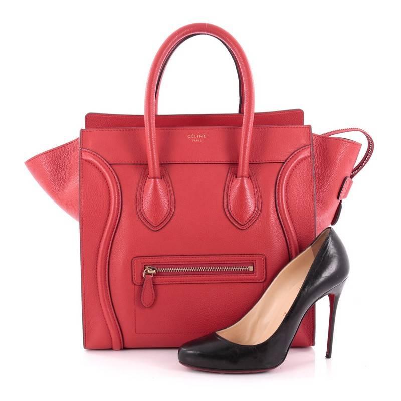 This authentic Celine Luggage Handbag Grainy Leather Mini epitomizes Phoebe Philo's minimalist yet chic style. Constructed in red grainy leather, this beloved fashionista's bag features dual-rolled leather handles, a frontal zip pocket, Celine's