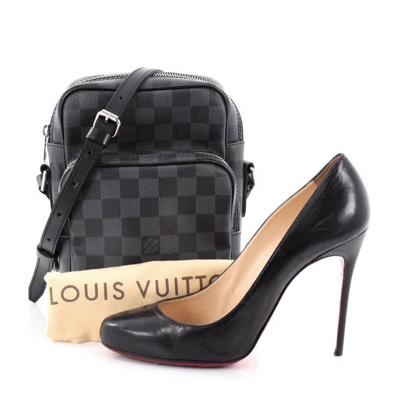 This authentic Louis Vuitton Rem Bag Damier Graphite is perfect for on-the-go fashionistas. Crafted in damier graphite coated canvas, this messenger bag features exterior front zip pocket, long adjustable leather crossbody strap and silver-tone