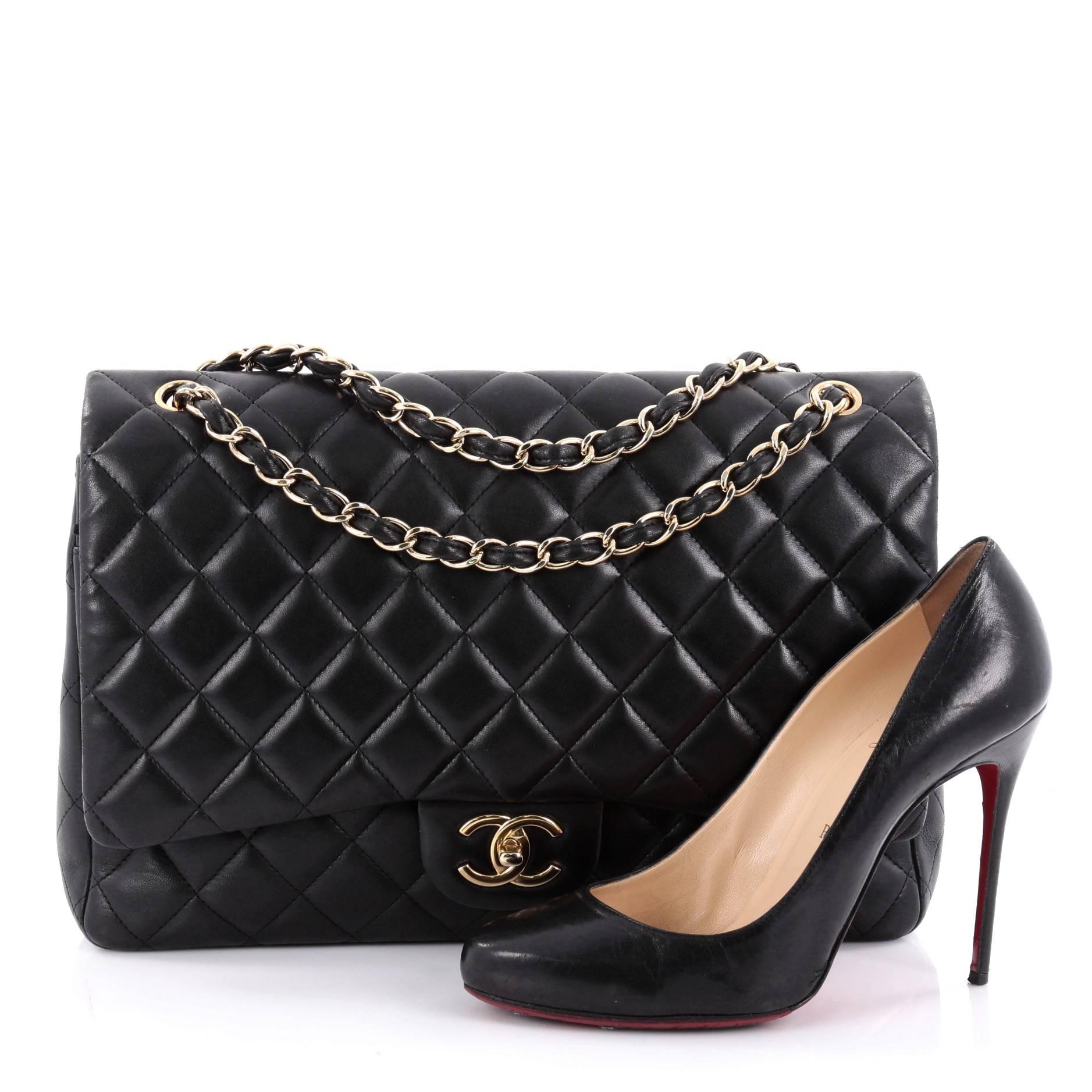 This authentic Chanel Classic Double Flap Bag Quilted Lambskin Maxi exudes a classic yet easy style made for the modern woman. Crafted from black lambskin leather, this elegant flap features Chanel's signature diamond quilted design, woven-in