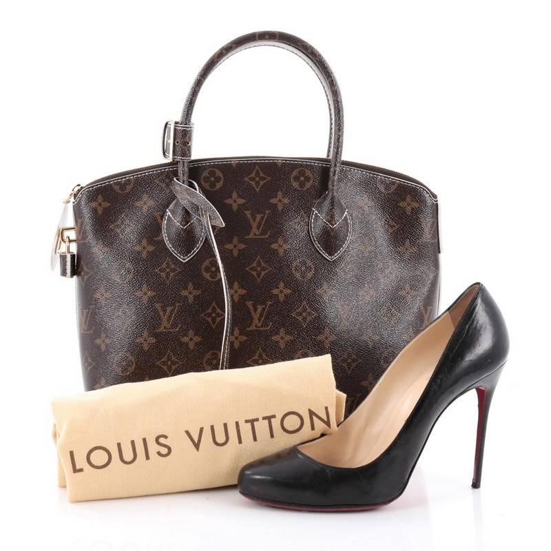 This authentic Louis Vuitton Lockit Handbag Monogram Fetish Canvas, released during Fall/Winter 2011/2012, plays on structured design with a modern flair showcasing its iconic Lockit model. Crafted in Louis Vuitton's updated brown monogram canvas