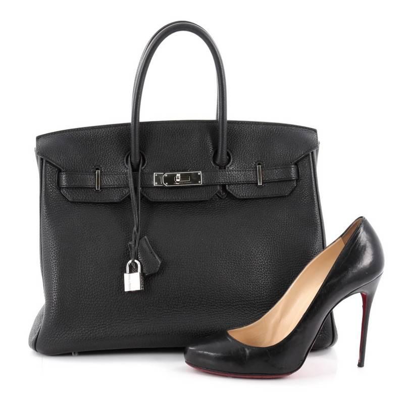 This authentic Hermes Birkin Handbag Black Togo with Palladium Hardware 35 stands as one of the most-coveted bags. Constructed from scratch-resistant, iconic black togo leather, this stand-out tote features dual-rolled top handles, frontal flap,