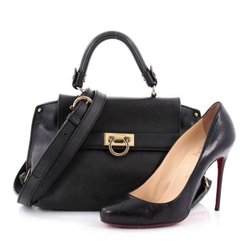 This authentic Salvatore Ferragamo Sofia Satchel Smooth Leather Small is stylish and functional. Crafted in black smooth leather, this bag features a sturdy top handle with exterior back zip pocket, protective base studs and gold-tone hardware