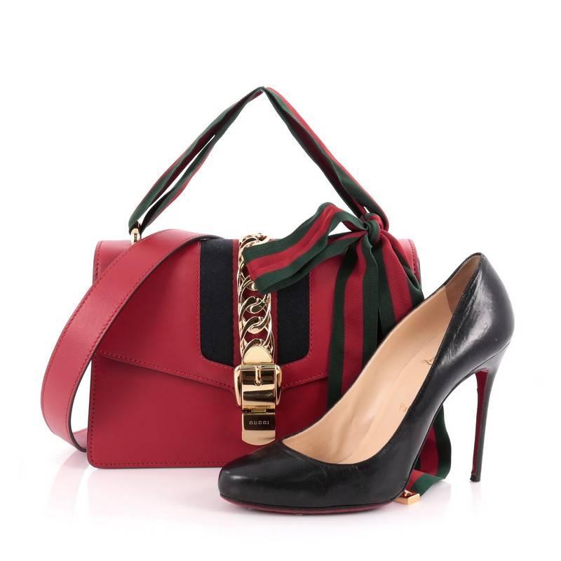 This authentic Gucci Sylvie Shoulder Bag Leather is from the brand's Spring 2016 Collection that's perfect for the modern fashionista. Crafted from red leather, this structured bag features web shoulder strap, detachable leather shoulder strap,