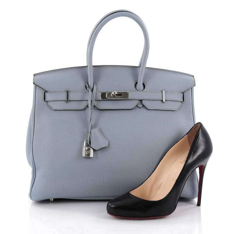 This authentic Hermes Birkin Handbag Bleu Lin Togo with Palladium Hardware 35 stands as one of the most-coveted bags. Constructed from scratch-resistant, iconic light blue togo leather, this stand-out tote features dual-rolled top handles, frontal