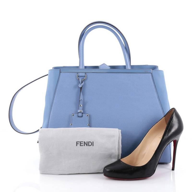 This authentic Fendi 2Jours Handbag Leather Medium is impeccably stylish with a simple silhouette and structured design. Finely crafted in sturdy sky blue leather with soft calfskin sides, this popular tote features a shining top bar that dons the