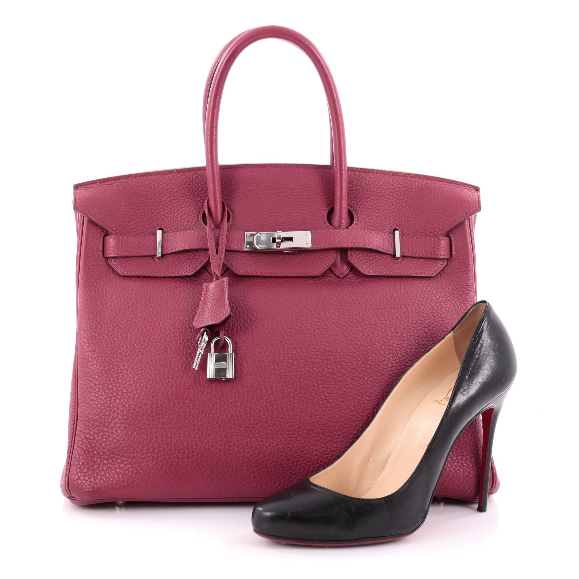 This authentic Hermes Birkin Handbag Rubis Clemence with Palladium Hardware 35 is synonymous to traditional Hermes luxury. Crafted with sturdy, scratch-resistant rubis red clemence leather, this eye-catching luxurious tote is accented with polished