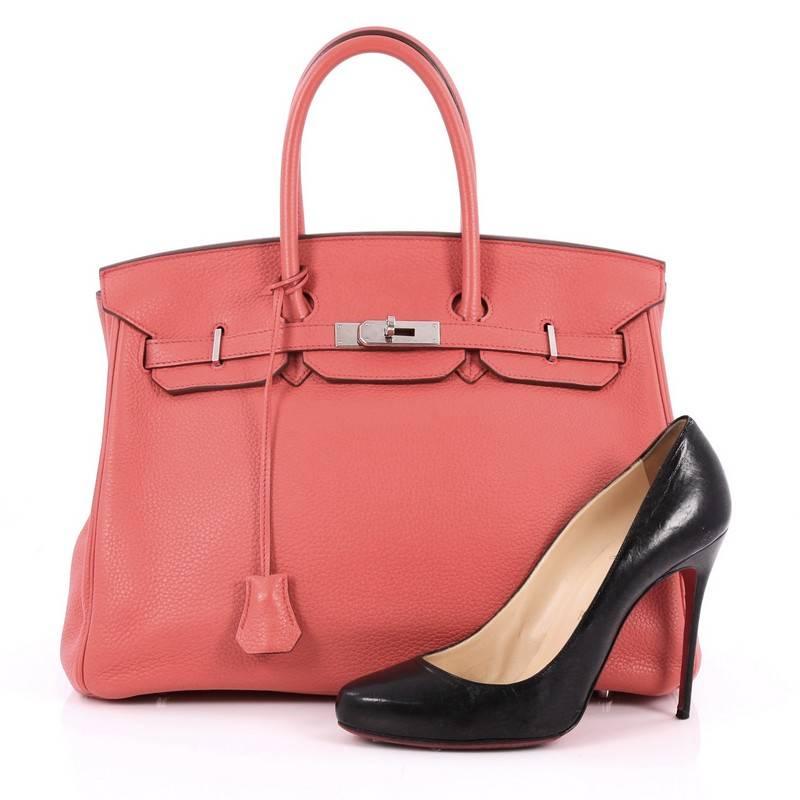 This authentic Hermes Birkin Handbag Bougainvillea Clemence with Palladium Hardware 35 stands as one of the most-coveted bags. Crafted from scratch-resistant, iconic Bougainvillea coral clemence leather, this stand-out tote features dual-rolled top