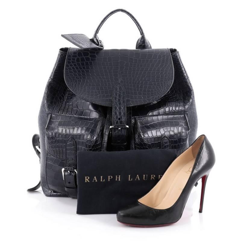 This authentic Ralph Lauren Collection Two Pocket Drawstring Backpack Crocodile Medium is versatile and stylish bag perfect for on the go moments. Crafted from genuine navy blue crocodile skin, this backpack features, top handle, adjustable shoulder