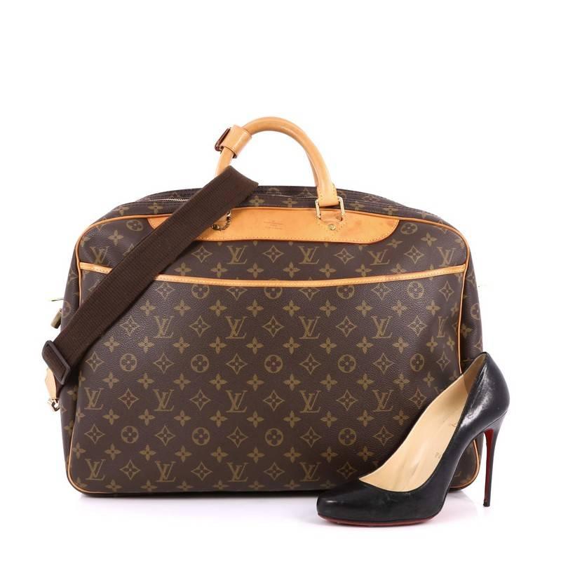 This authentic Louis Vuitton Alize Bag Monogram Canvas 24 Heures is stylish alternative to square soft suitcase, perfect for a carry-on or weekend travel. Crafted from brown monogram coated canvas with leather trims, this oversized travel bag