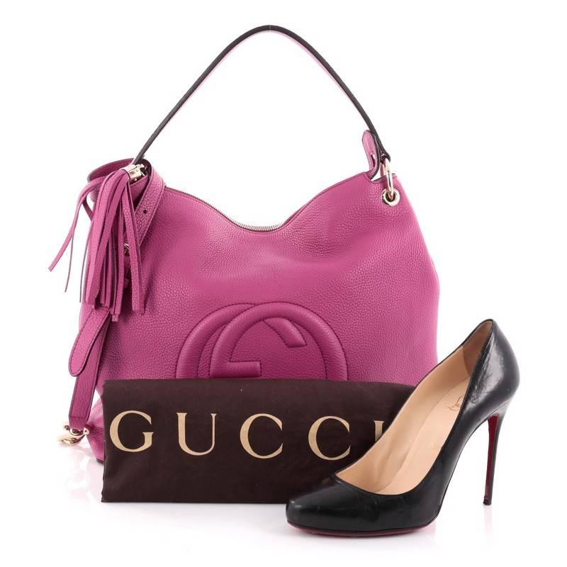 This authentic Gucci Soho Convertible Hobo Leather Large is a fresh, casual-chic hobo made for everyday excursions. Crafted from fuchsia leather, this no-fuss hobo features Gucci's signature interlocking GG logo stitched at the front, single loop