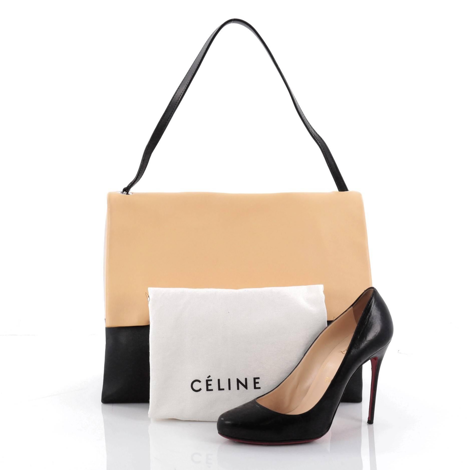 This authentic Celine All Soft Tote Leather is an understated look perfect for the modern woman. Crafted in creme, light yellow and black leather, this fresh, minimalist tote features a single leather shoulder strap, subtle stamped Celine logo and