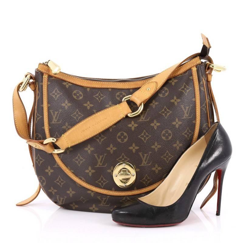 This authentic Louis Vuitton Tulum Handbag Monogram Canvas GM is a unique, functional everyday piece for any Louis Vuitton lover. Crafted from the brand’s signature brown monogram coated canvas, this elegant hobo features vachetta leather strap and